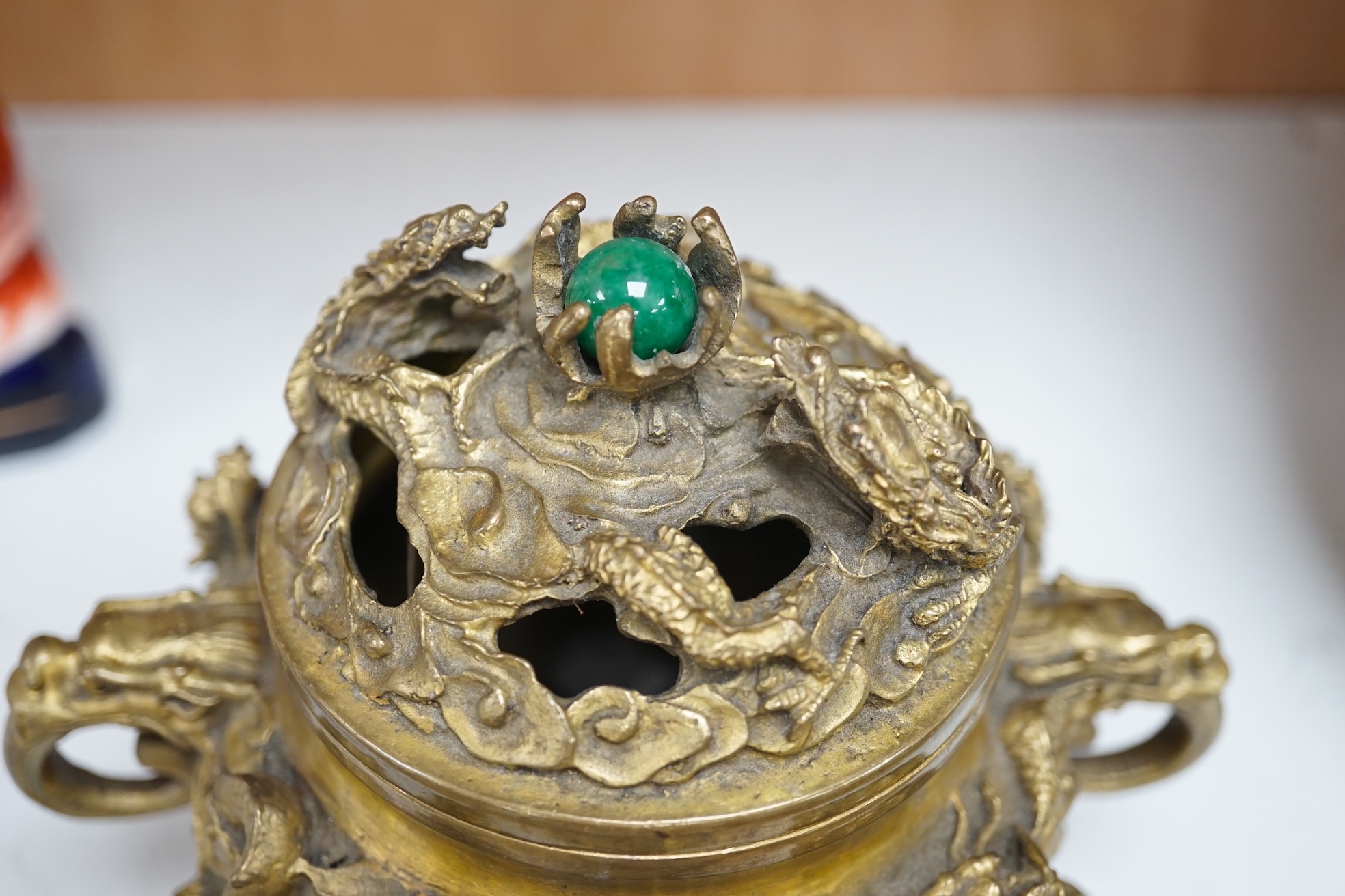 A Chinese bronze lidded censer, with jade bead insert in the finial, 15cm high. Condition - good.